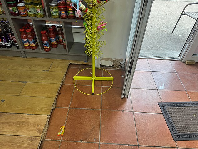 But when MailOnline visited, the shop had litter on the floor and a cracked wall