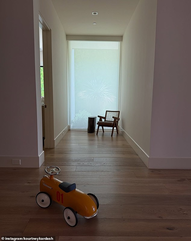 Also included in the slideshow was a photo of what appeared her and Travis' one-year-old son Rocky's scooter sitting idly in the hallway of their home