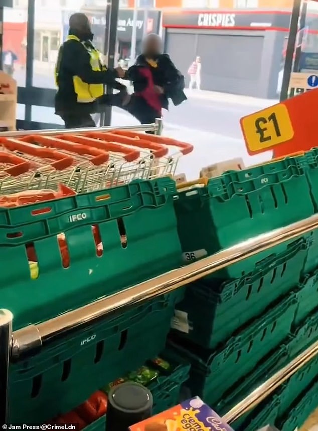 Moment Iceland security guard arms himself with a shopping basket to ward off thief aiming kicks at him