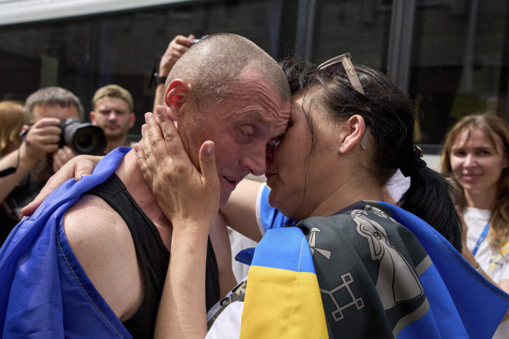 Ukrainian serviceman Vitaly kisses his wife, Olena, after returning from captivity during a POWs exchange between Russia and Ukraine, in Chernyhiv region, Ukraine, Sunday, May 25, 2025. (AP Photo/Efrem Lukatsky)