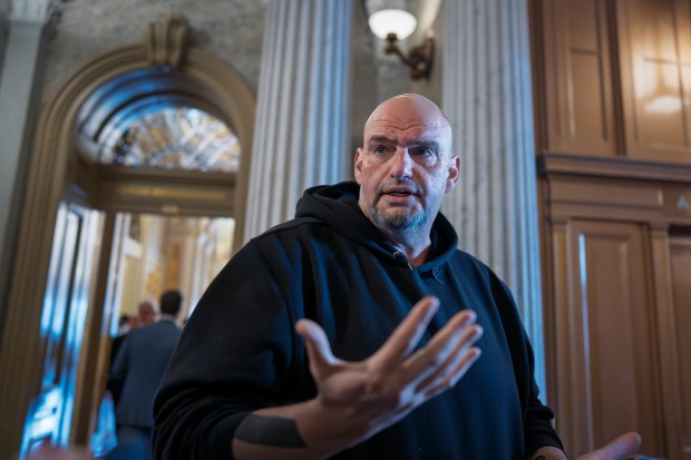 Sen. John Fetterman, D-Pa., talks to reporters outside the chamber during a vote at the Capitol in Washington, March 13, 2025. (AP Photo/J. Scott Applewhite, File)