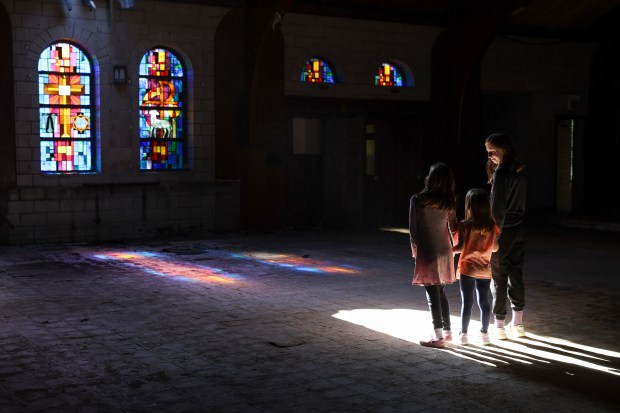 Sisters Vivian, left, Lucia, and Isabel Fitzgerald stand in St....