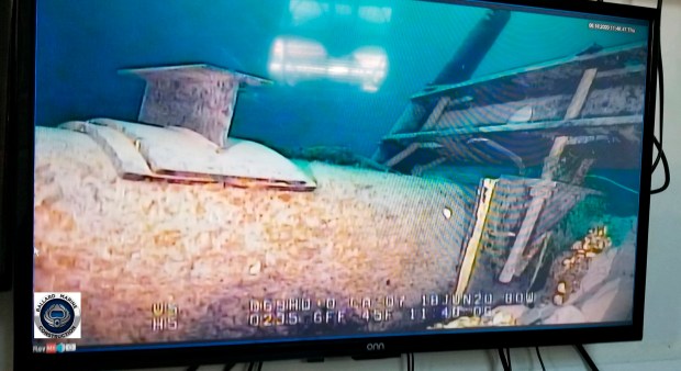 Footage played on a television screen shows damage to anchor support EP-17-1 on the east leg of the Enbridge Line 5 pipeline within the Straits of Mackinac, Mich., in June 2020. (Michigan Department of Environment, Great Lakes, and Energy)