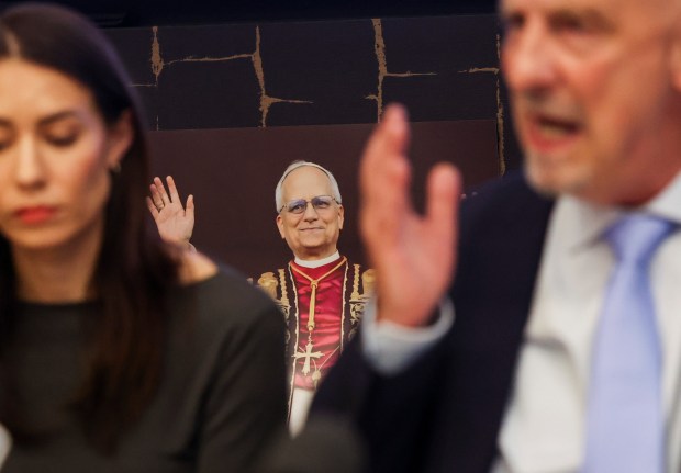 A photograph of Pope Leo XIV rests on a table behind Peter Isely, one of the founders of Survivors Network of those Abused by Priests and a survivor of sexual abuse by a priest, as he speaks during a press conference discussing Pope Leo XIV's past and what SNAP would like him to do regarding sexual abuse in the Catholic church, on May 20, 2025. (Eileen T. Meslar/Chicago Tribune)
