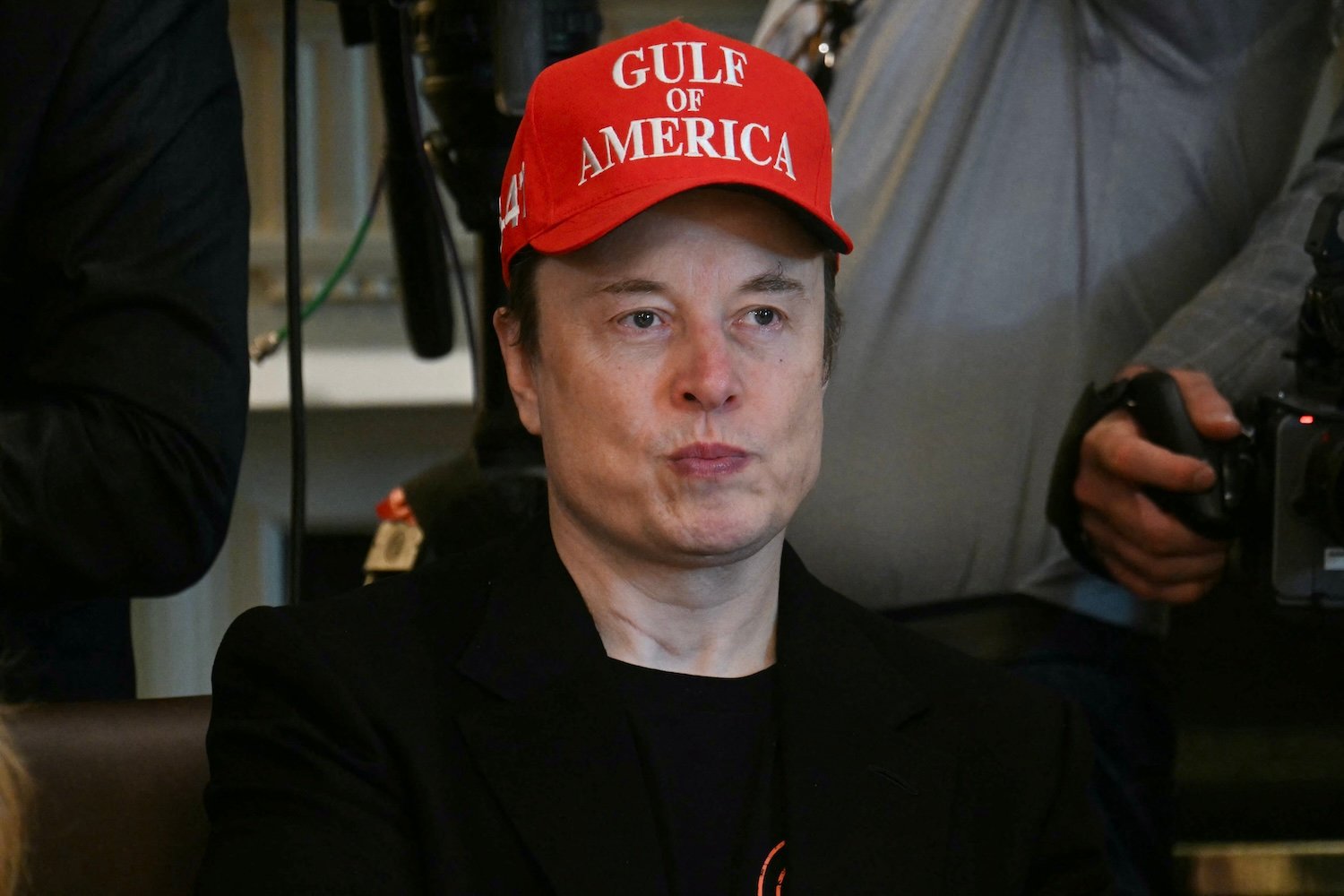 Musk wears a red had that reads "GULF OF AMERICA."