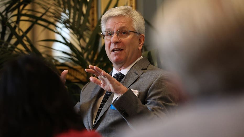 Federal Reserve Christopher Waller in a brown blazer