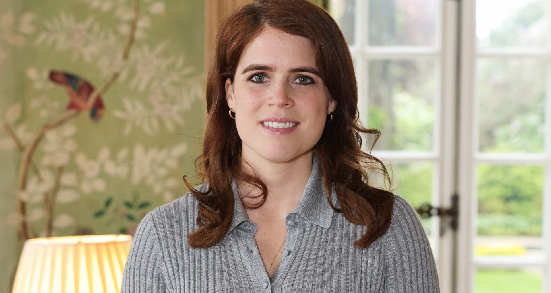 Princess Eugenie of York smiles as she attends a reception and panel discussion on the fashion industry's commitment to sustainability