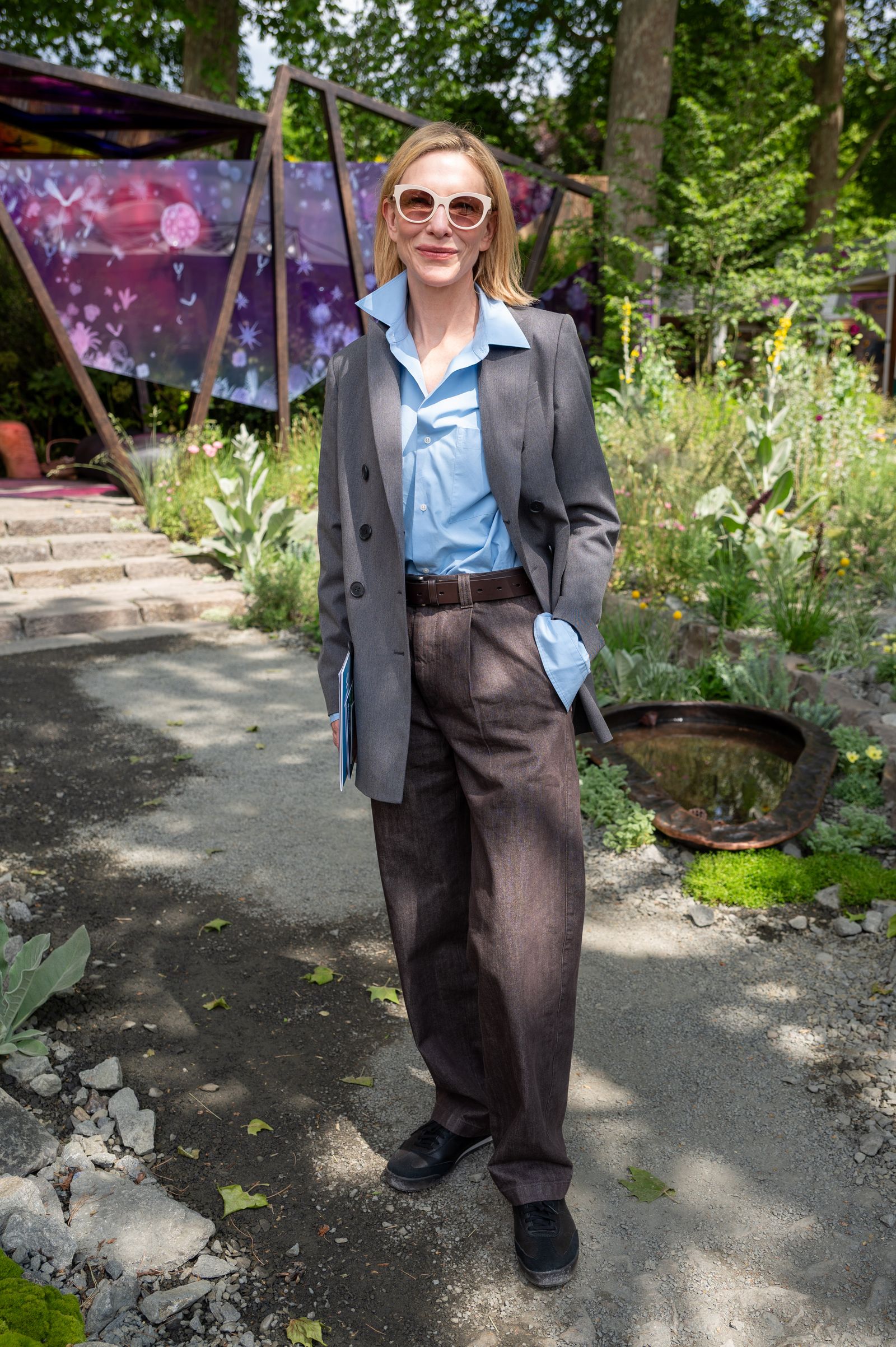 Image may contain Cate Blanchett Blazer Clothing Coat Jacket Plant Potted Plant Jar Planter Pottery and Vase