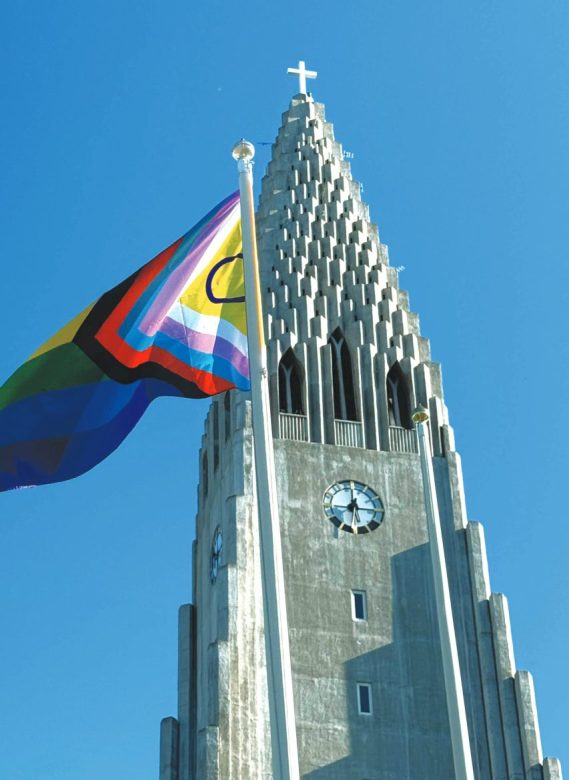 Hallgrímskirkja and the Inclusive Pride Flag (Photo by DepartureLevel.com)