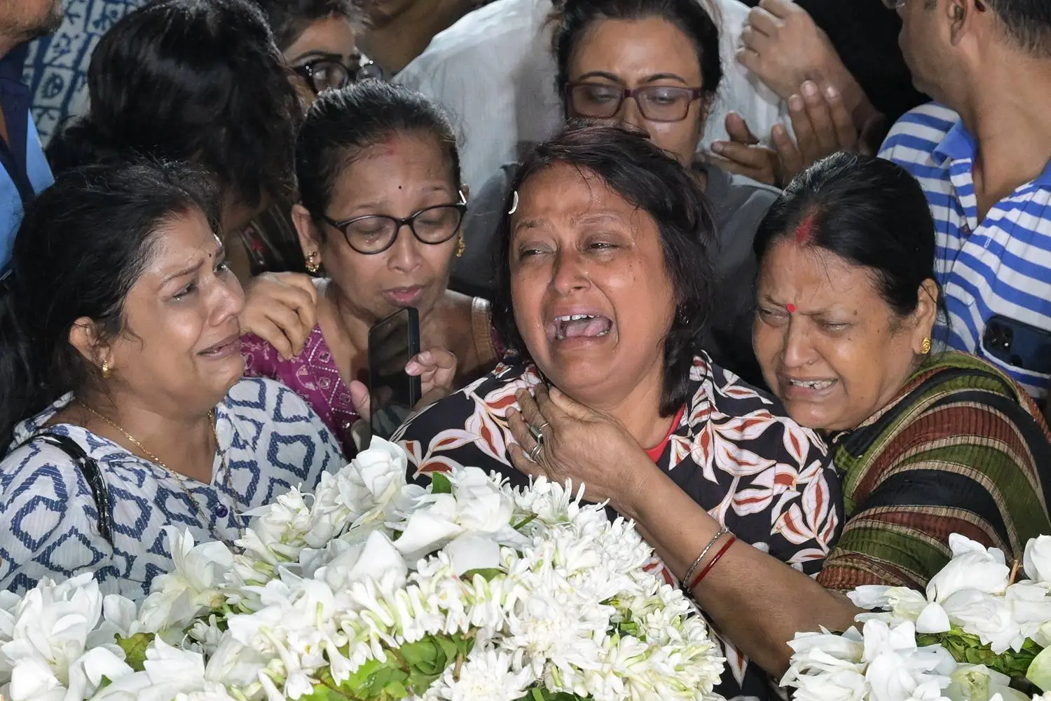 The wife of Sameer Guha, an Indian tourist killed by gunmen near Pahalgam in Kashmir, mourns during her husband's funeral in Kolkata, India, on April 23.