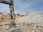 A backhoe was brought in to excavate mass graves in Jobar on March 26.