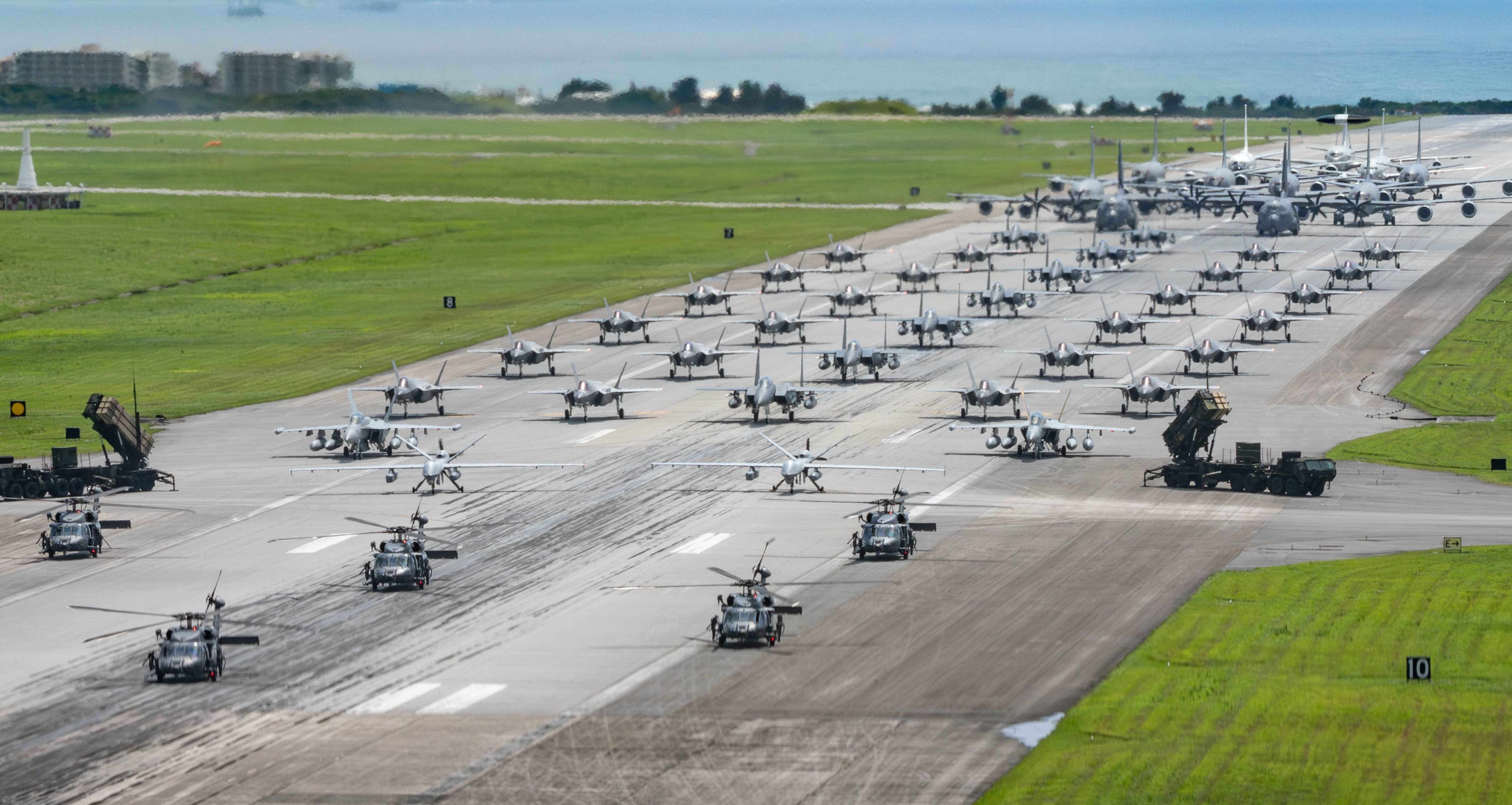 U.S. Air Force, U.S. Army and U.S. Navy assets line up on the runway for an elephant walk during a routine operational readiness exercise at Kadena Air Base, Japan, May 6, 2025. Team Kadena showcased an array of aircraft, demonstrating a portion of the 100+ aircraft operating from the Keystone of the Pacific. (U.S. Air Force photo by Senior Airman Tylir Meyer)