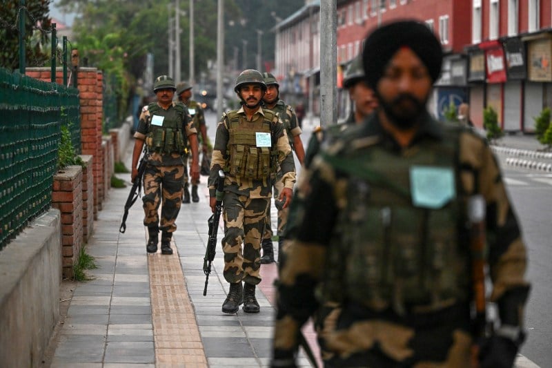 Indian security personnel patrol along a street in Srinagar, in Jammu and Kashmir, on Aug. 15.