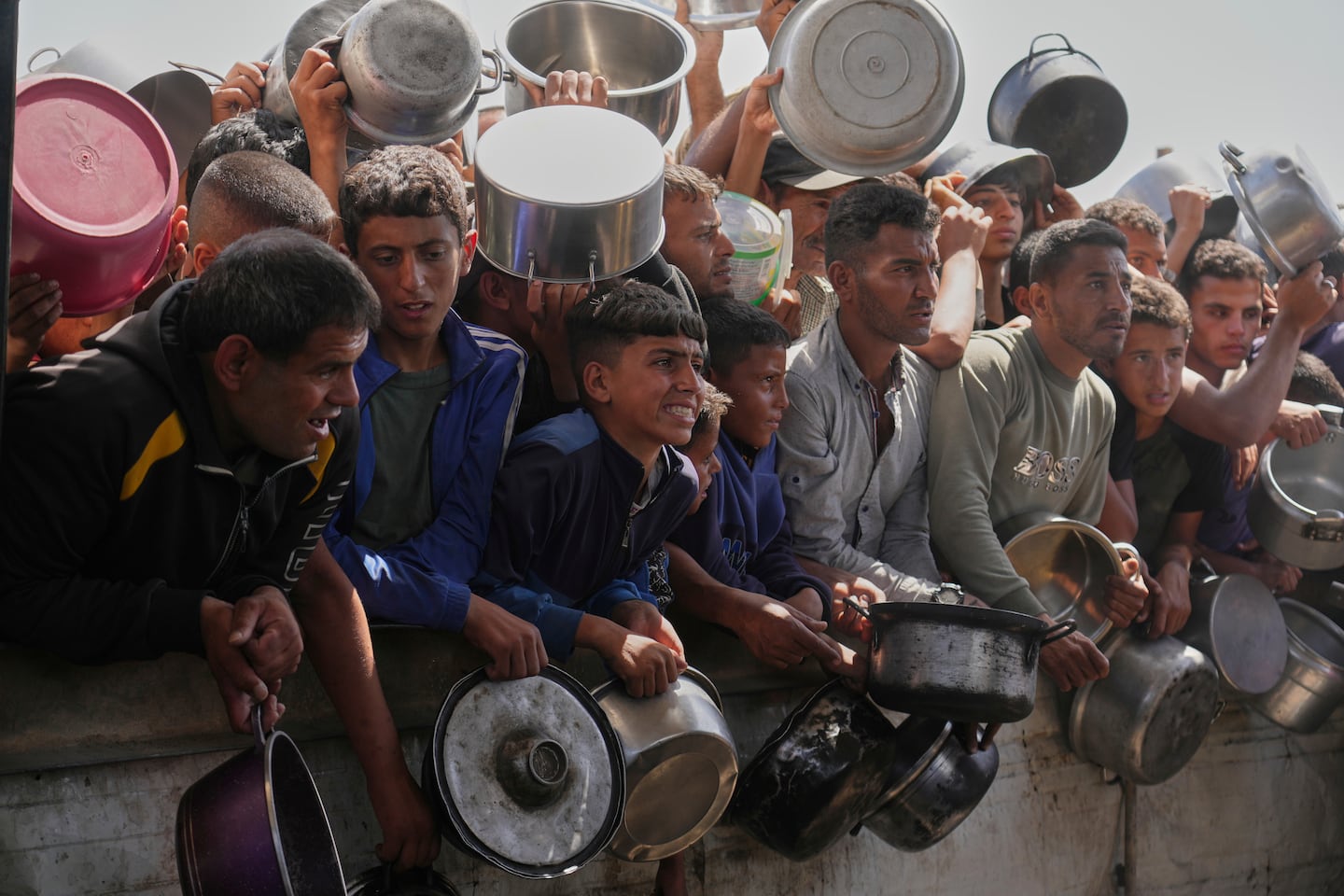 Palestinians struggled to obtain donated food at a community kitchen in Khan Younis, in the southern Gaza Strip, on Friday.
