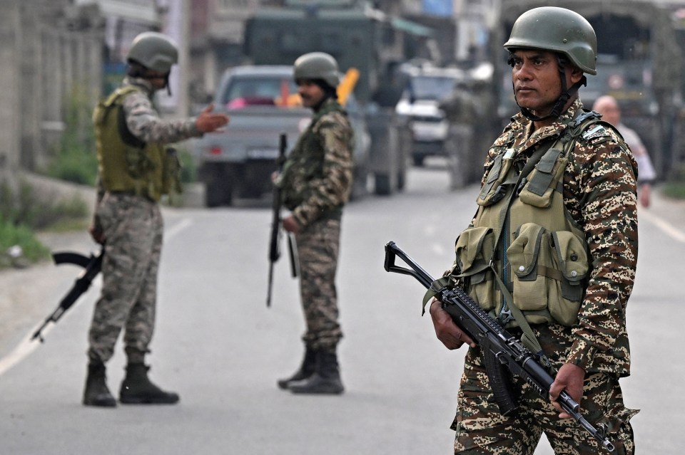 Indian security personnel stand guard in Wuyan near Srinagar on May 7, 2025, following border tensions. India and Pakistan exchanged heavy artillery along their contested frontier on May 7, after New Delhi launched missile strikes on its arch-rival in a major escalation between the nuclear-armed neighbours. New Delhi announced it had carried out "precision strikes at terrorist camps" at nine sites in Pakistan-administered Kashmir, days after it blamed Islamabad for a deadly attack on the Indian-run side of the disputed region. (Photo by Tauseef MUSTAFA / AFP) (Photo by TAUSEEF MUSTAFA/AFP via Getty Images)