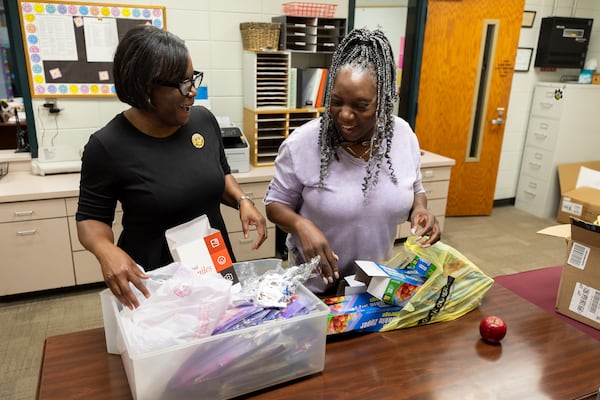 Ruskin Elementary School Principal Donna Solomon (left) and Oneida Oliver-Sanders, mother of Army Reserve Sgt. Kennedy L. Sanders, go through Memorial Day craft kits in honor of Kennedy Sanders at Ruskin Elementary in Waycross on May 16, 2025.  (Arvin Temkar/AJC)