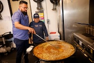 Adán Ventura (left) and Hector Campos cooked at Tasty Paella on May 14 in Richardson....