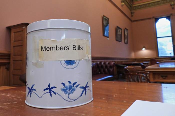 In New Zealand's Parliament, a battered cookie tin decides which new laws get debated