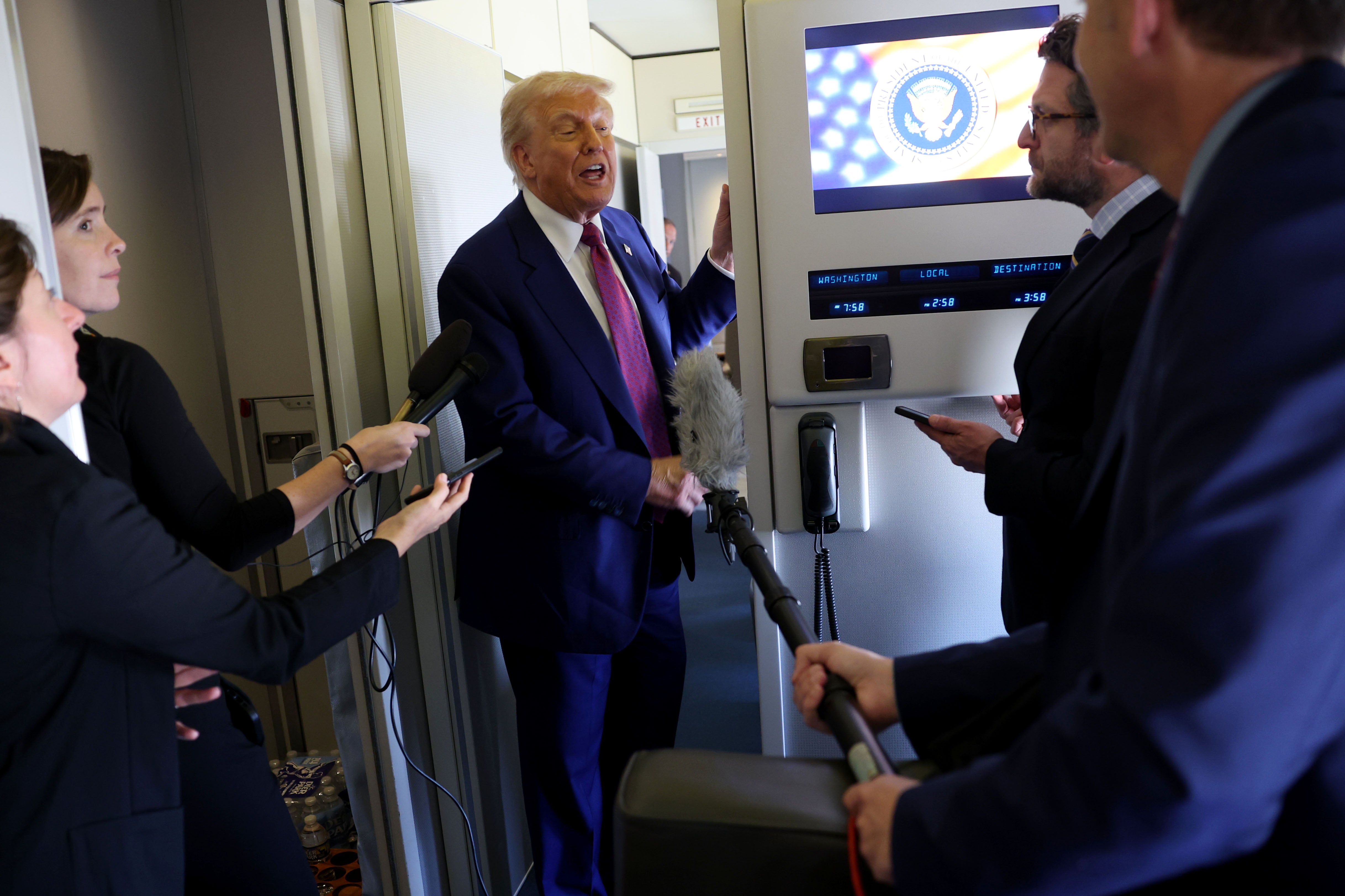 Trump speaks to journalists as he departs the Al Udeid Air Base for Abu Dhabi
