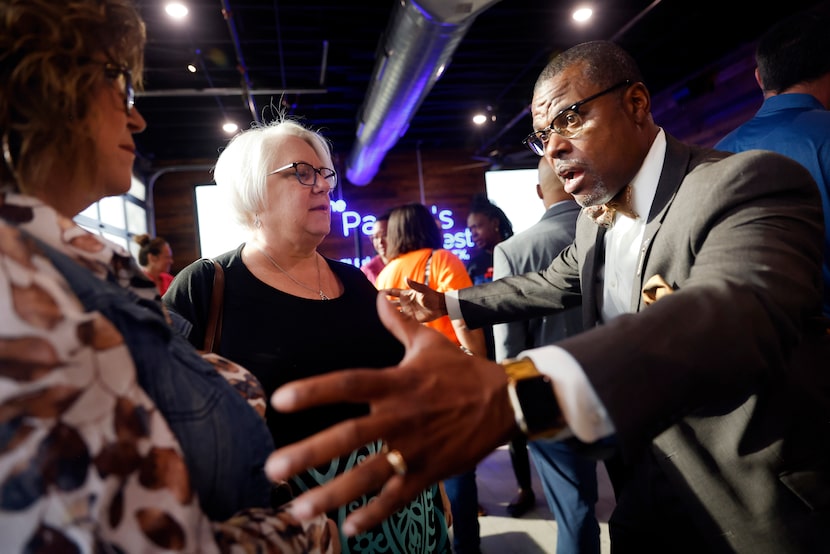 Mansfield Mayor Michael Evans (right) visits with supporters Susan Luttrell (center) and...