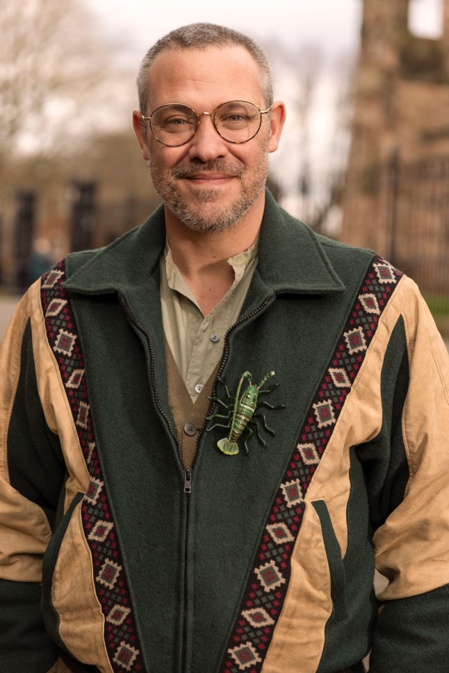 A close up of Will Young in a jacket with an insect on it