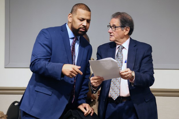 Then-Dolton Village Trustee Jason House, left, speaks to city attorney Bert Odelson before a public meeting in a Dolton Park District building, Feb. 22, 2024. (Terrence Antonio James/Chicago Tribune)