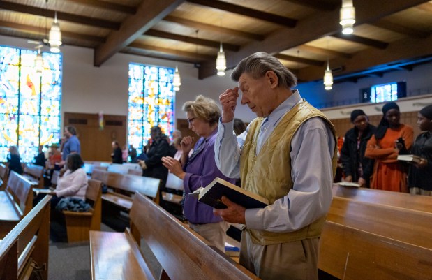 George Klein and his sister Angie Miles pray during Mass on May 11, 2025, at Christ Our Savior Catholic Church in South Holland. Pope Leo XIV attended St. Mary of the Assumption Parish in Riverdale, which later consolidated with St. Jude to form Christ Our Savior. (Brian Cassella/Chicago Tribune)