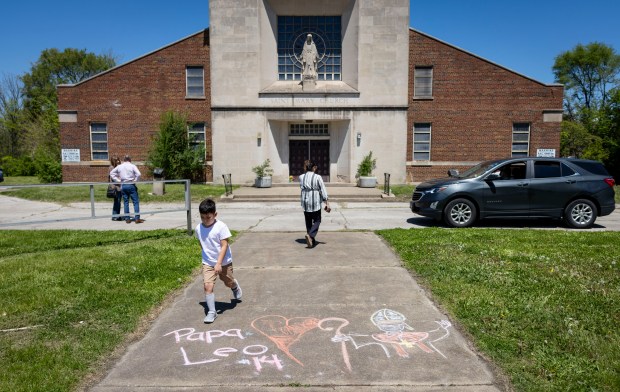 Chalk messages are left for new Pope Leo XIV outside...