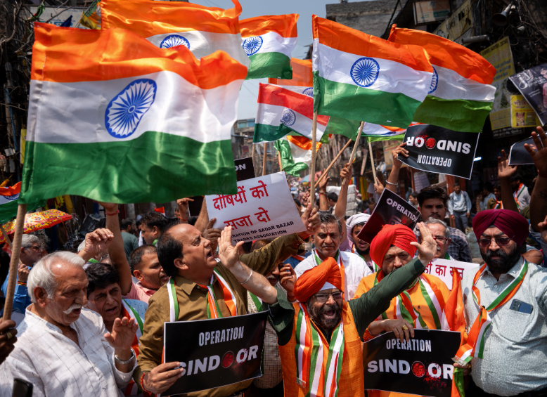 Activists wave Indian national flags and display banners reading