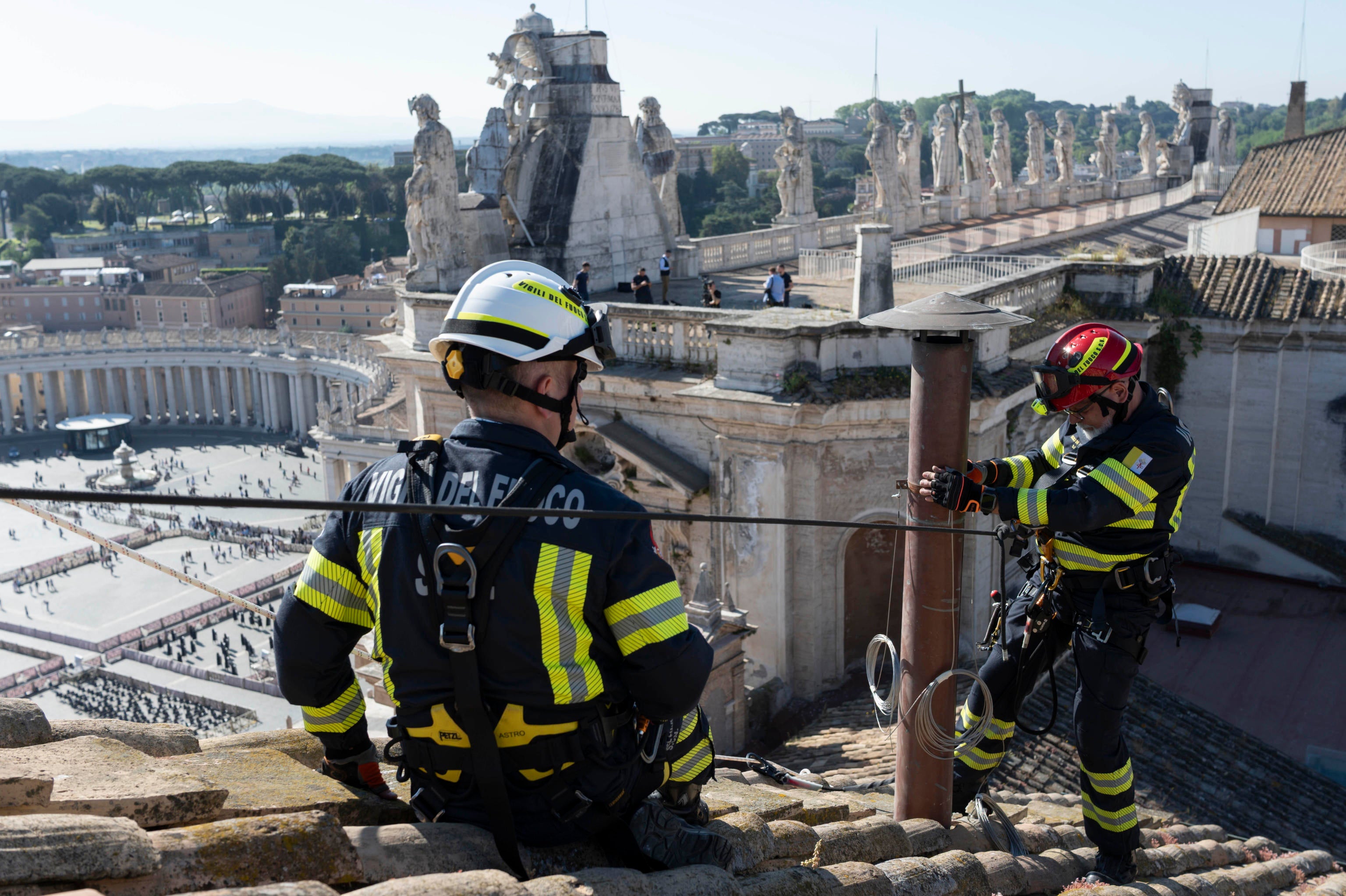 Firefighters installing the chimney atop the Sistine Chapel
