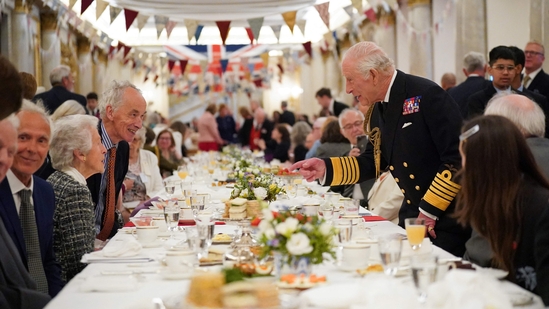 Britain's King Charles III (R) speaks with Second World War veteran during a tea party at Buckingham Palace on May 5, 2025 to celebrate the 80th anniversary of VE Day also known as Victory in Europe Day.(AFP)