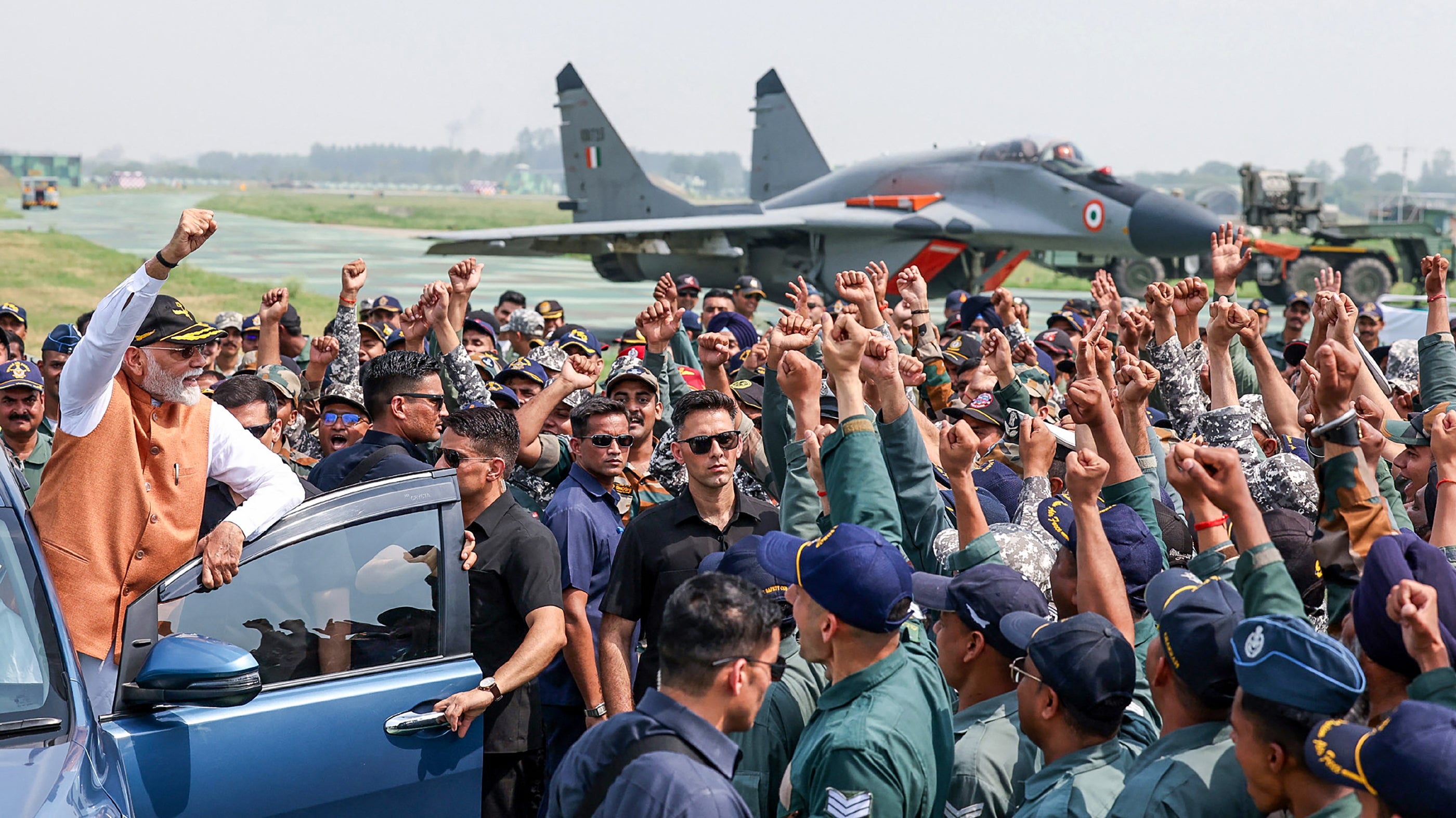 India's Prime Minister Narendra Modi (L) during his visit to Adampur Airforce Base in India's state of Punjab on May 12