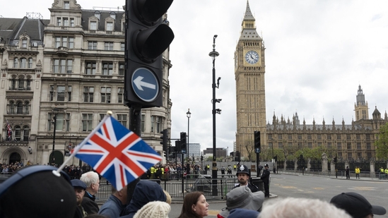 Onlookers watch the VE Day 80 procession as members of the British Armed Forces pass the Houses of Parliament in London, UK, on Monday, May 5, 2025. The UK is marking the 80th anniversary of Victory in Europe, or VE Day, when Britain and its allies accepted the surrender of Nazi Germany. Photographer: Jose Sarmento Matos/Bloomberg(Bloomberg)