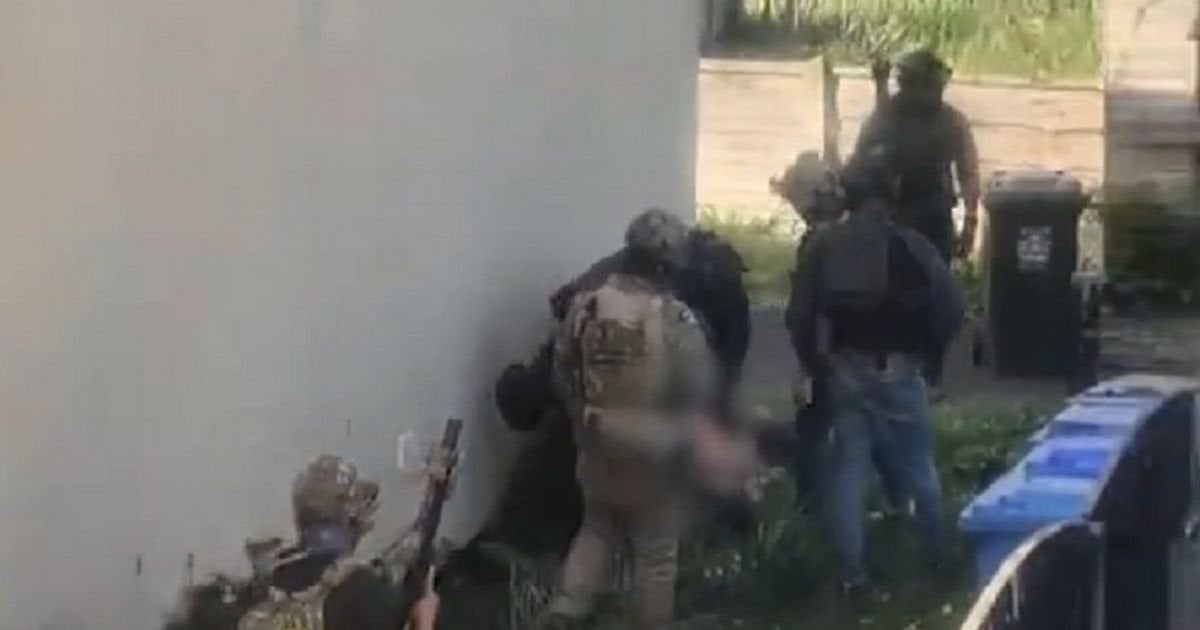 Armed counter terror police storm home after 'blowing off door' and 'throwing gas canister'