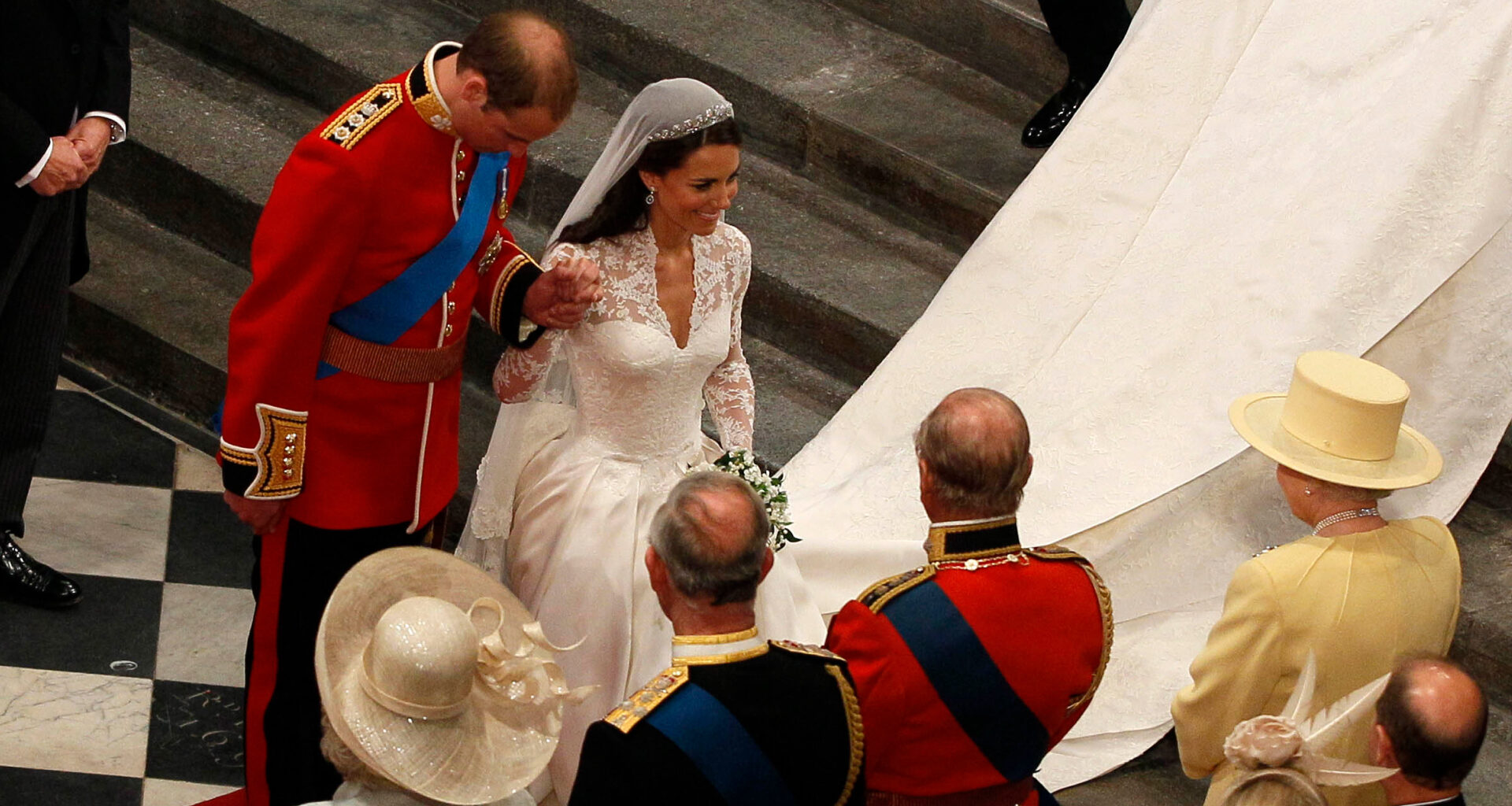 Prince William bowing and Kate Middleton curtsying to Queen Elizabeth at their wedding