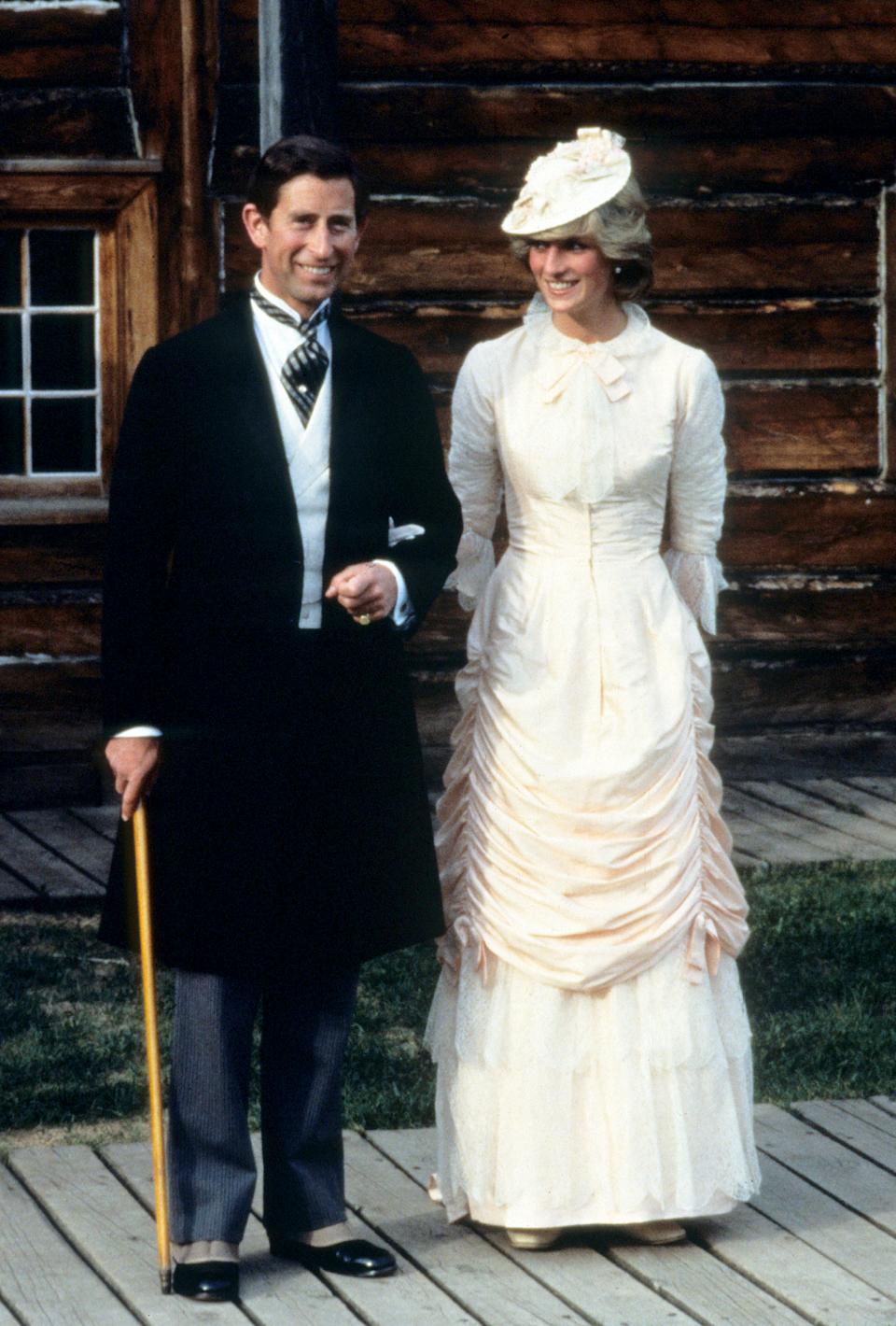 FORT EDMONTON, CANADA - JUNE 29: Prince Charles, Prince of Wales and Diana, Princess of Wales, wearing traditional Klondike (klondyke) style outfits, attend a Klondike evening barbeque on June 29, 1983 at Fort Edmonton, Canada. Princess Diana's silk dress was designed by Linda Mattock and had been previously worn by actress Francesca Annis who played Lillie Langtry in the 1978 mini-series 'Lillie.' (Photo by Anwar Hussein/Getty Images)