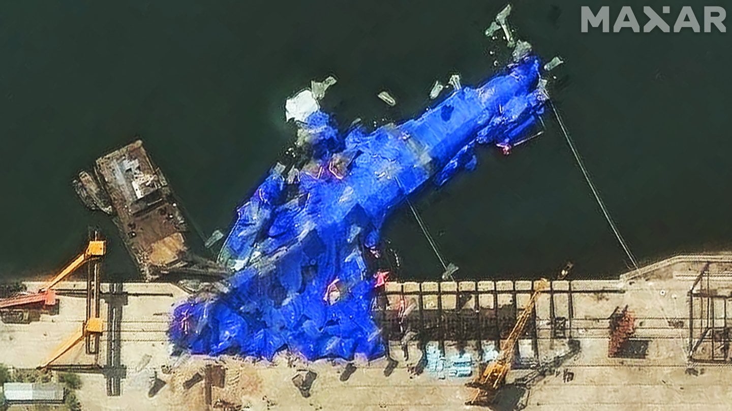 A day after an embarrassing mishap during a launch ceremony attended by dictator Kim Jong Un, North Korean authorities are trying to right the 5,000-ton frigate. The warship rolled over and partially submerged
