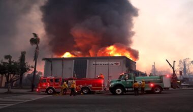 Los Angeles County firefighters attempt to put out a fire at a Bank of America as the Eaton Fire, which destroyed many homes and businesses, moves through Altadena, California