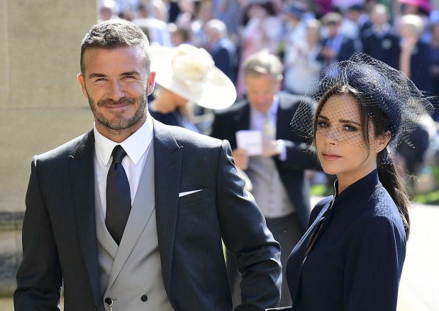 Former England footballer David Beckham (L) and fashion designer Victoria Beckham (R) arrive for the wedding ceremony of Britain's Prince Harry, Duke of Sussex and US actress Meghan Markle at St George's Chapel, Windsor Castle, in Windsor, on May 19, 2018. (Photo by Ian West / POOL / AFP) (Photo credit should read IAN WEST/AFP/Getty Images)