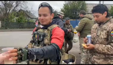 Colombian volunteers who came to defend Ukraine eating and drinking a meal offered by civilians.