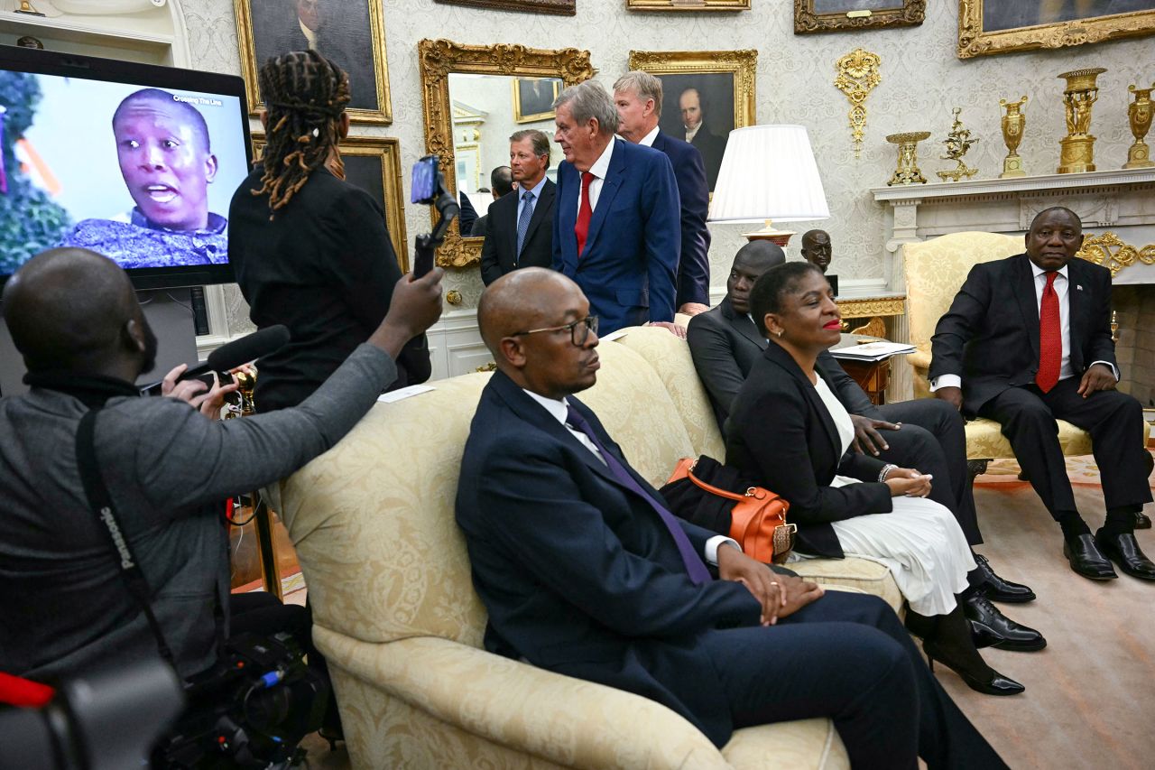 A video is played as South African President Cyril Ramaphosa, right, looks on during a meeting US President Donald Trump in the Oval Office of the White House in Washington, DC, on May 21.
