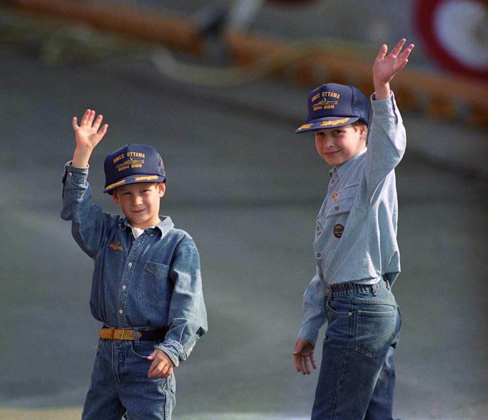 Prince William, 9, and his younger brother, Prince Harry, 7, wear baseball-style caps given to them by the crew of the Canadian frigate HMCS Ottowa after they toured the ship which is moored alongside the Royal Yacht Britannia on the Toronto waterfront. (Photo by Martin Keene - PA Images/PA Images via Getty Images)