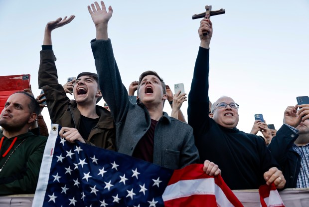 Americans from Texas including Cole Wendling, center, celebrate after the...