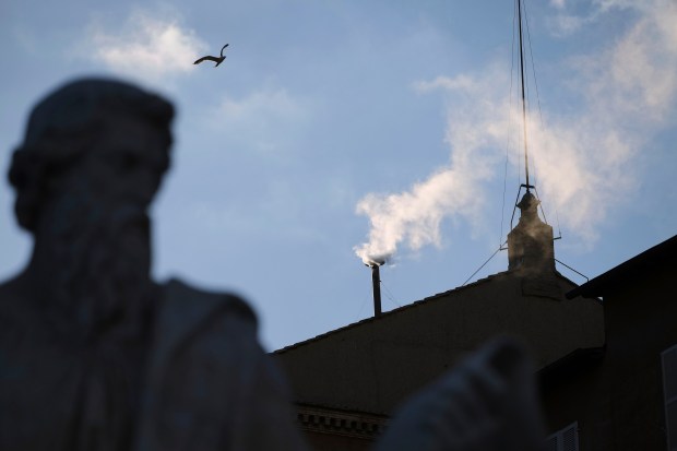 White smoke billows from the chimney of the Sistine Chapel...
