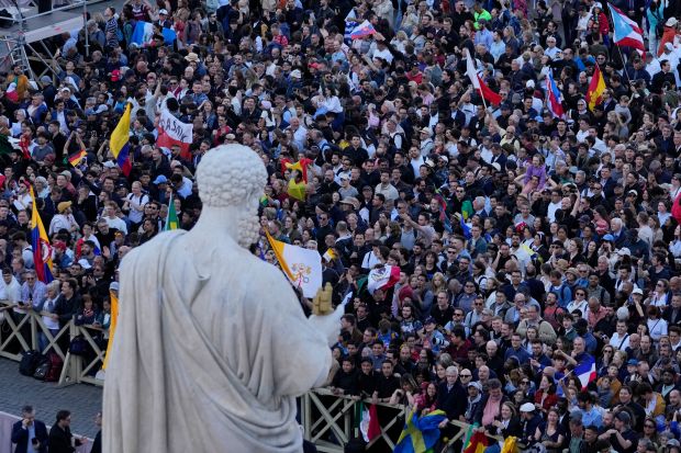 Crowds cheer in St. Peter's Square after the election of...