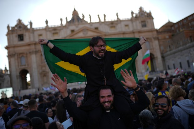 Clerics celebrate after white smoke appeared on May 8, 2025,...