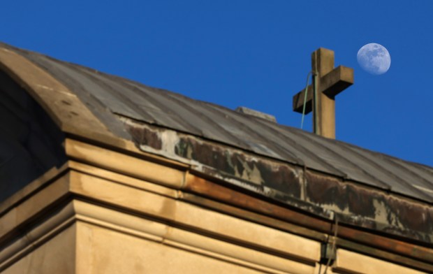 A waxing crescent moon rises above the former St. Mary...