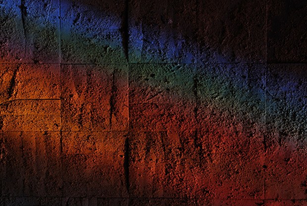 Tiles illuminated by stained glass windows are covered in dust...