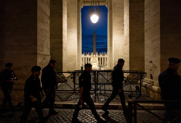 Security officers arrive before dawn in St. Peter’s Square s...