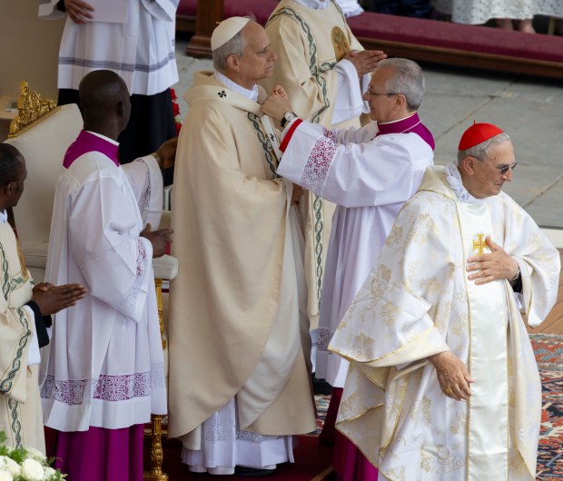 Pope Leo XIV receives the pallium as he’s installed during...